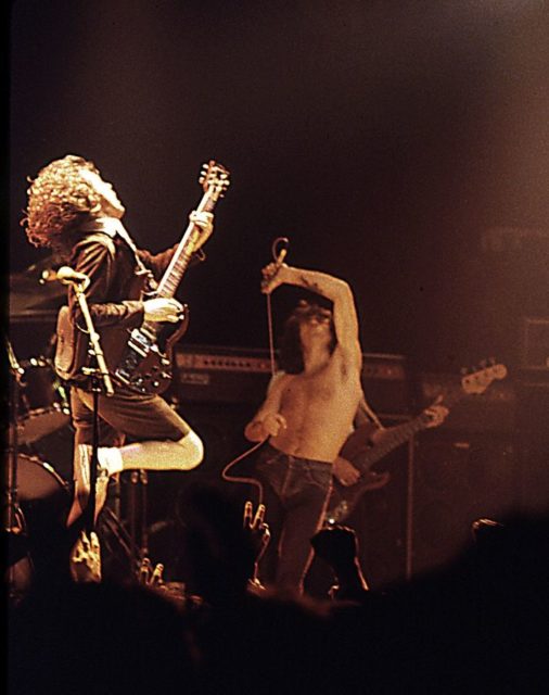 Former AC/DC vocalist Bon Scott (centre) pictured with guitarist Angus Young (left) and bassist Cliff Williams (back), performing at the Ulster Hall in August 1979. Photo Credit