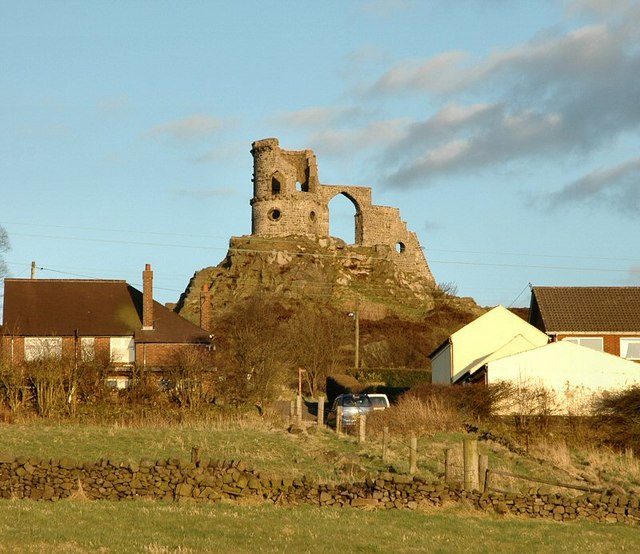 Mow Cop Castle viewed from the fields below the village. Photo Credit