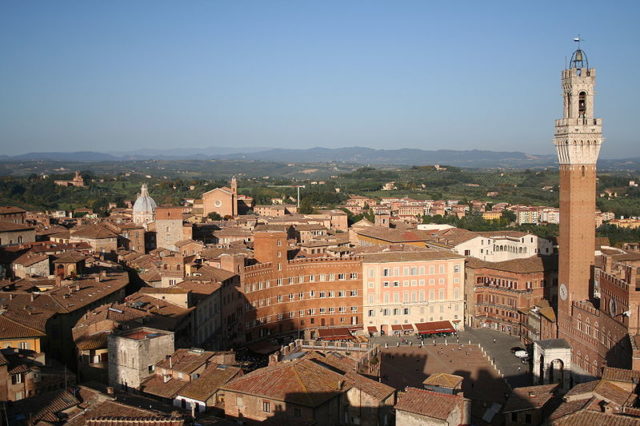 View of Piazza del Campo (Campo Square), the Mangia Tower (Torre del Mangia) and Santa Maria in Provenzano Church Photo Credit