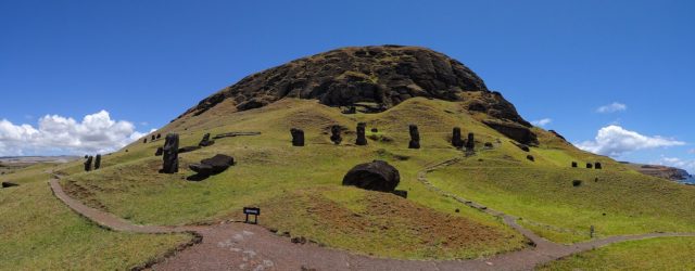 Outer slopes of Rano Raraku with many moai; some half-buried, some left still “under construction” near the mountain. Photo Credit