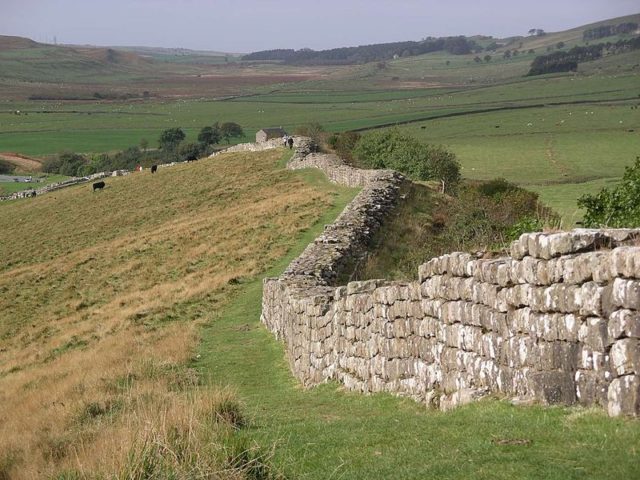 Sections of Hadrian’s Wall remain along the route, though much has been dismantled over the years, in order to use the stones for various nearby construction projects  Photo Credit