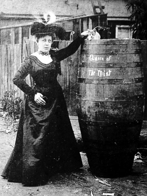“The Queen of the Mist” posing with her barrel and a cat