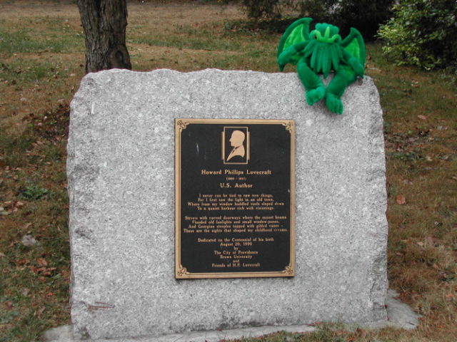 Plush-toy Cthulhu pays homage to his creator H. P. Lovecraft, at H.P. Lovecraft Memorial Plaque, Providence, Rhode Island. Photo Credit