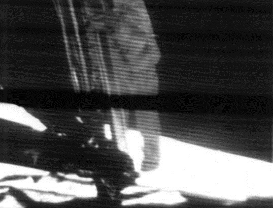 Neil Armstrong descends a ladder to become the first human to step onto the surface of the Moon.