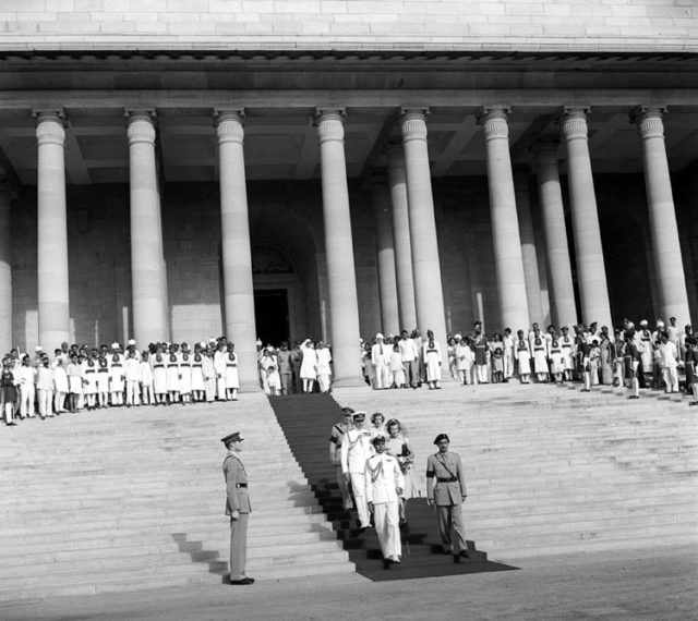 Earl and Countess Mountbatten of Burma, with Lady Pamela Mountbatten descending the steps of the Government House just before their departure, and H.E. Shri. C.Rajagopalachari at the front. Shri Jawaharlal Nehru appears behind. Photo credit