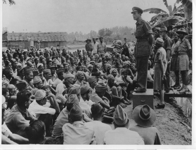 Lord Louis talks to released Indian prisoners of war in Singapore. Lady Louis stands behind him. Photo credit
