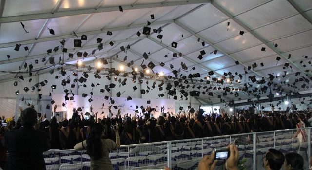 Graduation hats being tossed by fresh graduates in ISB (Hyderabad, India). Photo Credit
