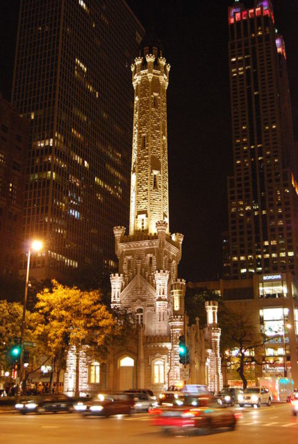 A stunning view at night of the Chicago Water Tower, photo credit