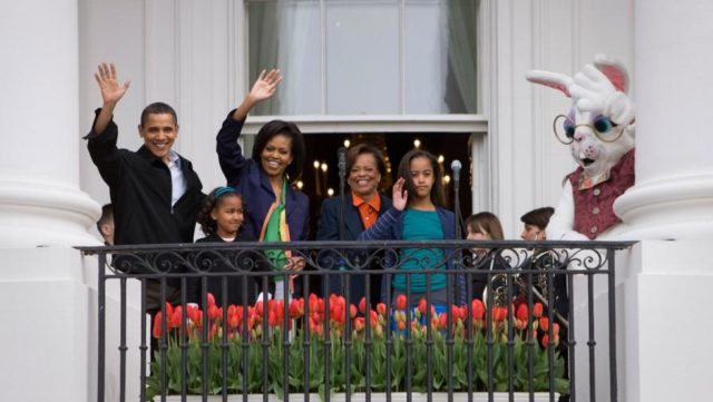 President Barack Obama and First Lady Michelle Obama are joined by their daughters, Sasha and Malia, and Michelle Obama’s mother, Marian Robinson, Monday, April 13, 2009, as they wave from the South Portico of the White House to guests attending the White House Easter Egg Roll