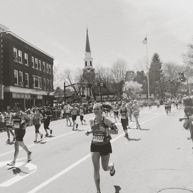 A woman running in the Boston Marathon. Photo Credit