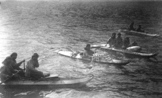 A photo showing King Island natives in kayaks.