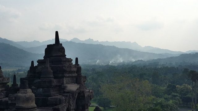 Borobudur Temple is surrounded by nearby mountains. Photo Credit