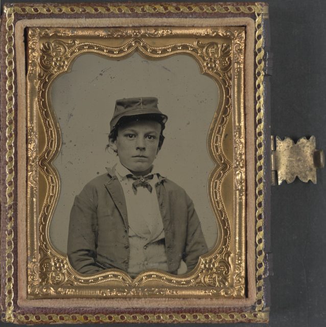 Unidentified young soldier in Confederate infantry uniform, possibly a drummer boy. Photo Credit
