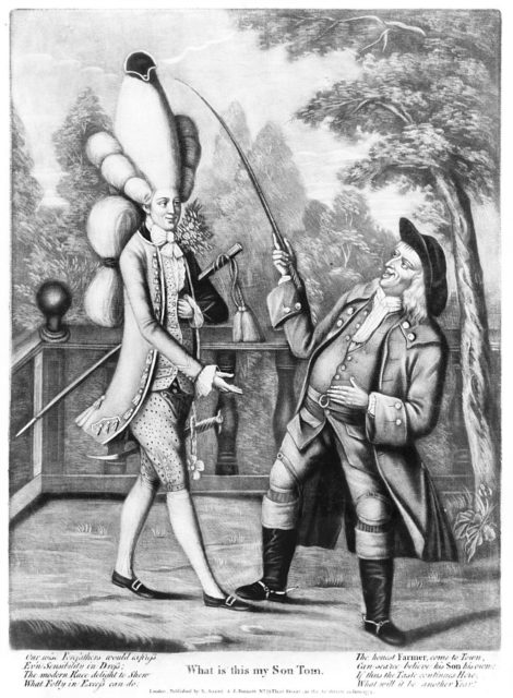 “What, is this my son Tom? –  A 1774 caricature originating in the Macaroni Print Shop in London depicted the extreme “Macaroni” fashion that was found throughout England.
