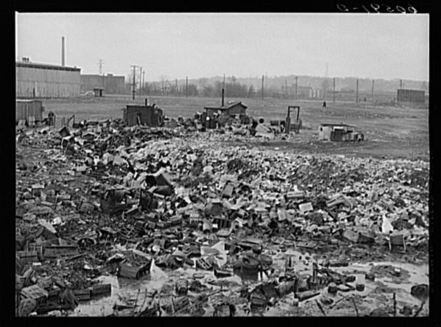 City dump. Dubuque, Iowa. In the background, there are shacks occupied by men who salvage anything marketable in the dump. Photo Credit