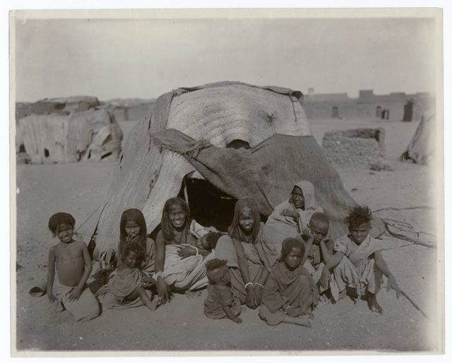 A_group_of_Bisharin_before_their_tent_at_Wady_Halfa,_Egypt.