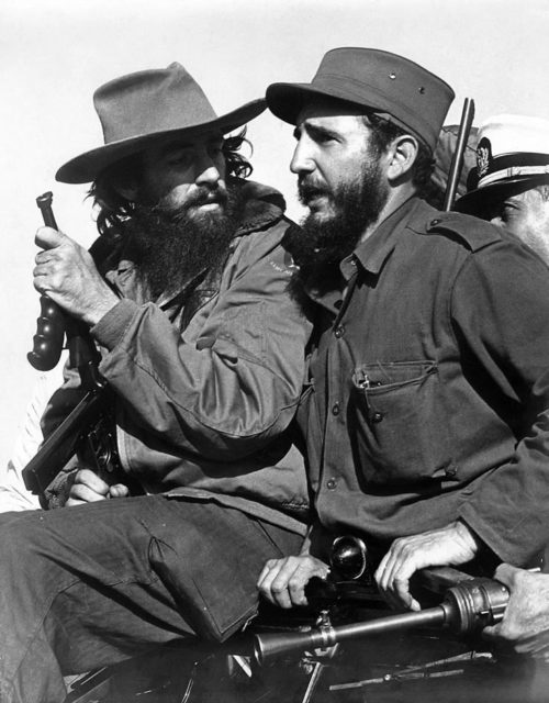 Cienfuegos, left, entering Havana with Fidel Castro in January 1959