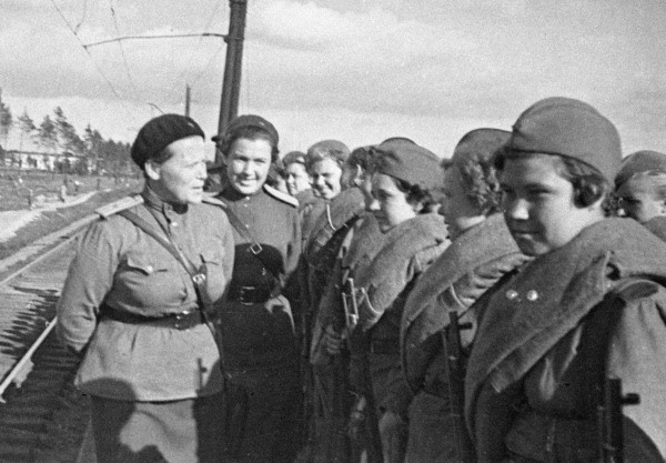 The chief of the political department of the Central High School of Economics, Major EN Nikiforova, talks with the sniper girls leaving for the front. April 1, 1943. Photo credit