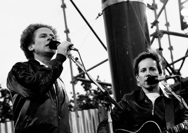 Paul Simon, right, with Art Garfunkel performing at a festival. Paul Simon greatly admires Jackson C. Frank and cites his work as inspirational. Photo Credit – Eddie Mallin.