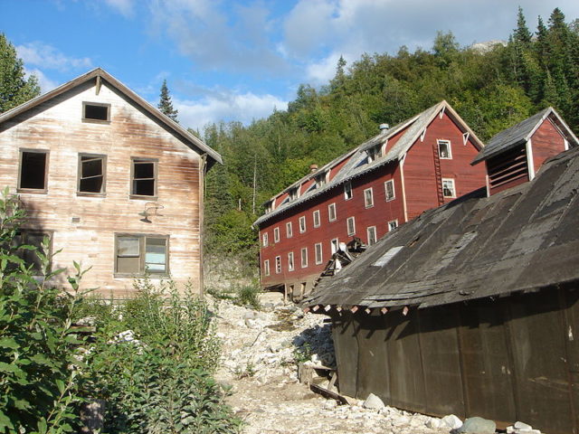 The Kennecott hospital (left) stood out as the town’s only white-washed building. The vast majority of the other town structures, including workers’ bunkhouses (right), were painted red, the least expensive color at the time. The Kennecott hospital was also the site of the first X-ray machine in Alaska
