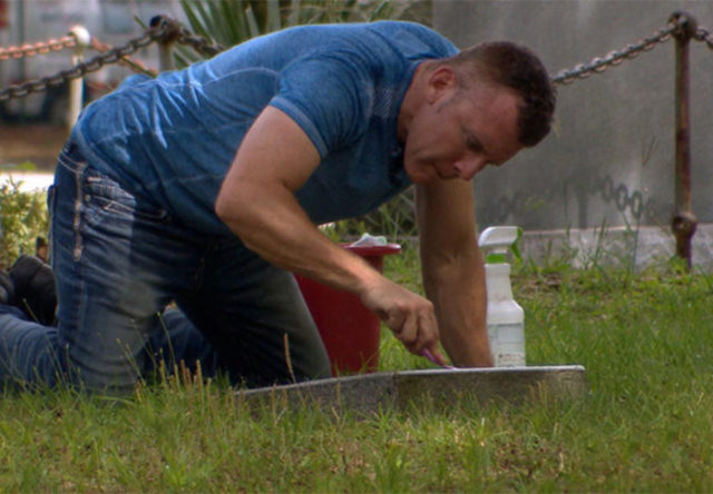 Man cleans veterans tombstones. Photo Credit : The Good Cemetarian