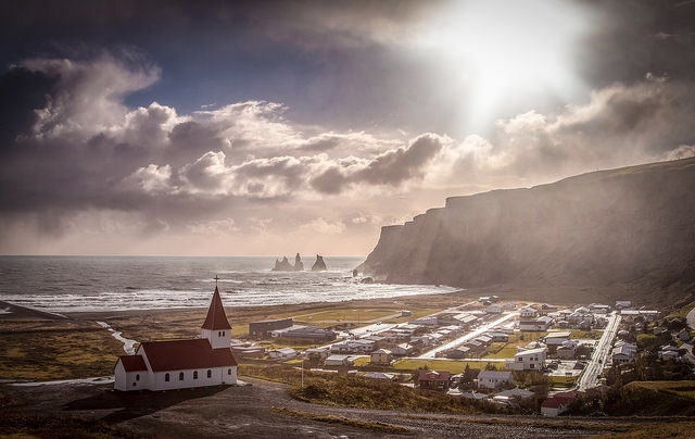 Spectacular view over the village of Vik and the black sanded volcanic seashore. Photo Credit