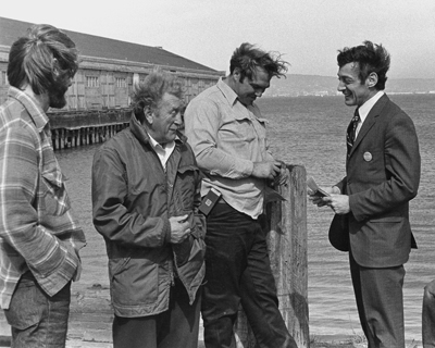 By the time of Milk’s 1975 campaign, he had decided to cut his hair and wear suits. Here, Milk (far right) is campaigning with longshoremen in San Francisco during his 1976 race for the California State Assembly.Daniel Nicoletta – CC BY-SA 3.0