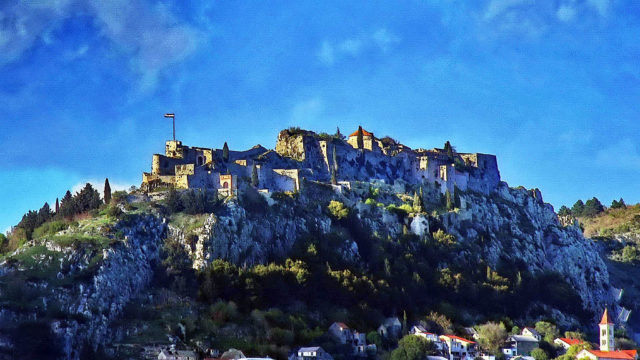 Perched on an isolated rocky cliff, inaccessible on three sides, the Fortress of Klis overlooks Split, located 11 kilometers (6.8 miles) from the Adriatic Sea. Photo Credit