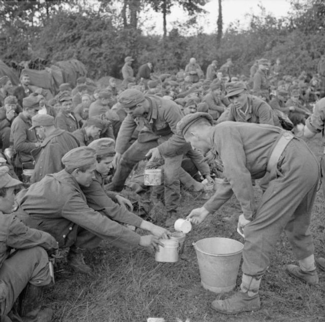 The British Army in Normandy 1944 – Tea is being served to German prisoners in the Falaise pocket, Aug. 22, 1944.