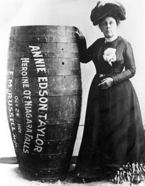 Photograph of Annie Edson Taylor, posing next to her barrel