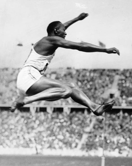 Owens performing the long jump at the Berlin Olympics. Photo by Bundesarchiv, Bild 183-G00630 / Unknown / CC-BY-SA 3.0.