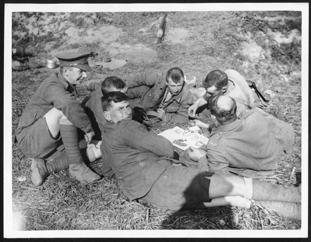 Men of the 8th Battalion, King’s Own Yorkshire Light Infantry playing cards near Ypres, October 1917.