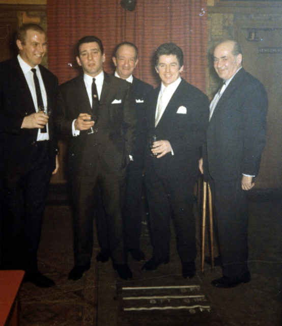 Photograph of London gangster Reginald Kray (second from left) taken in the months leading up to his trial in 1968. The evidence from this file and others resulted in him and his brother Ronald being sentenced to life imprisonment. Author:The National Archives CC BY-SA2.0