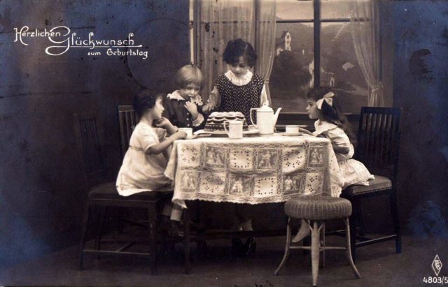 Girls with birthday cake. Postcard from 1920.