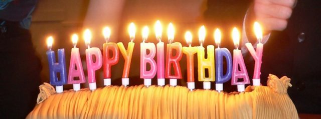 Candles spell out the traditional birthday greeting. Author: Ed g2s CC BY-SA 3.0