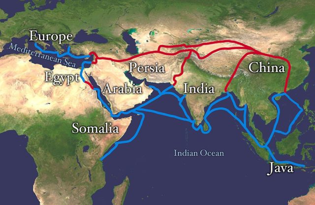 The red line marks the Silk Road, which was the most economically important route to transport goods from China, India, and Southeast Asia to Europe. The blue line marks the spice-trade routes that in 1453 were blocked by the Ottoman Empire, an event motivating the Europeans to search for a sea route around Africa, and ultimately triggering the Age of Discovery.
