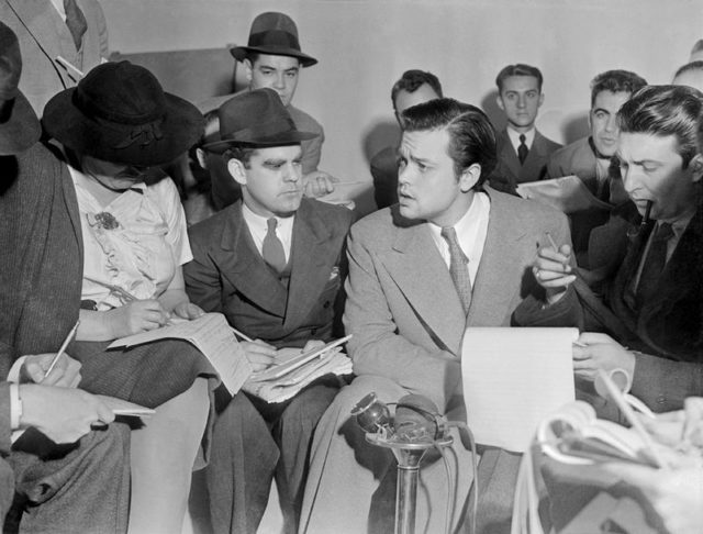 Photo of Orson Welles meeting with reporters in an effort to explain that no one connected with the War of the Worlds radio broadcast had any idea the show would cause panic.
