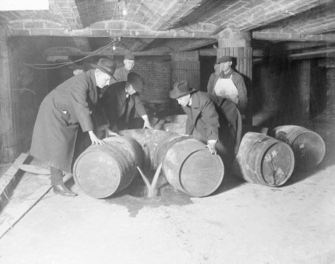 Prohibition agents destroying barrels of alcohol, c.1921.