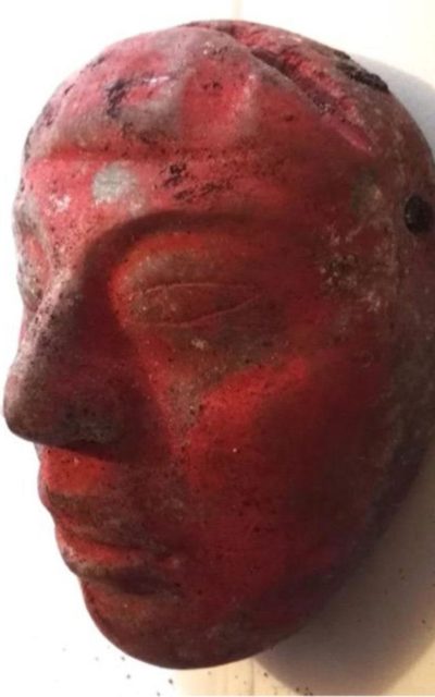 Red jade mask found at the burial. Author: Proyecto Arqueológico Waka’ and the Ministry of Culture and Sports of Guatemala