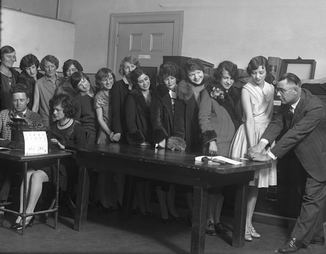 Women clerical employees of the Los Angeles Police Department being fingerprinted and photographed in 1928.