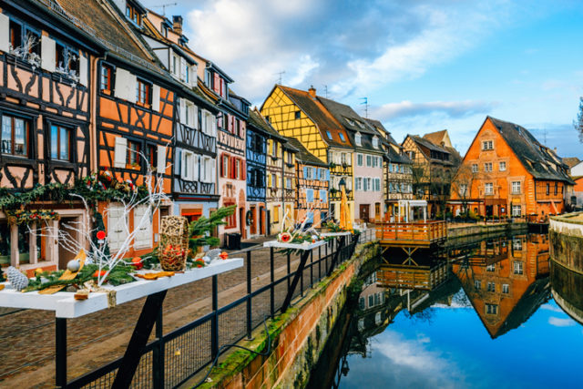 Water canal and traditional colored houses reflected in river Lauch at Noel time in Little Venise Colmar Haut-Rhin department Alsace France Europe
