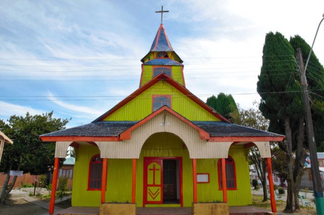 Yellow and red wooden church in Quemchi