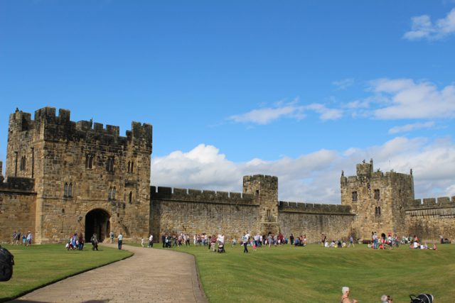 The walls of Alnwick Castle with people for scale