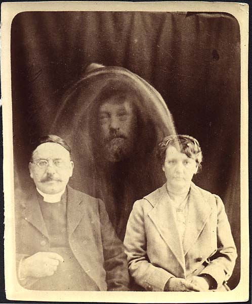 Rev. Charles L. Tweedale and Mrs. Tweedale with the alleged Spirit Form of F. Burnett. This spirit photograph like all of William Hope’s were exposed as fraudulent.