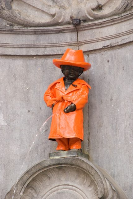 the statue of Manneke Pis, covered with a orange coat
