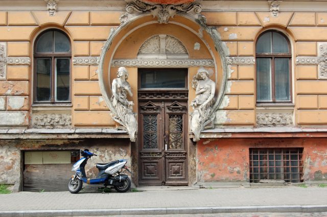 A lonely view to one of the beautiful Art Nouveau entrances in Riga, this one in bad condition.