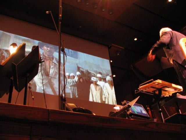 John Williams conducting the score to Raiders of the Lost Ark.Author: TashTish CC BY 3.0