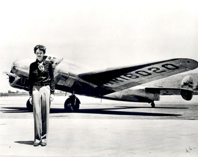 Amelia Earhart standing in front of the Lockheed Electra in which she disappeared in July 1937.
