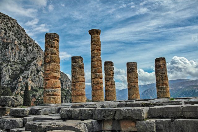 A view of the ancient columns and the ruins of the World Heritage Site the Temple of Apollo completed in 320 BC in Delphi Greece