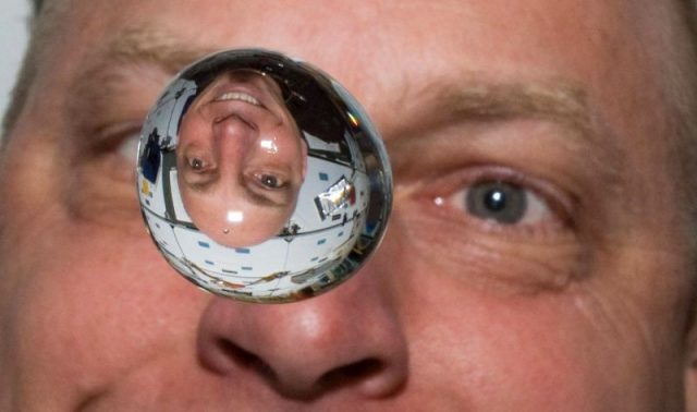 Anderson watches as a water bubble floats in front of him on the shuttle Discovery during the STS-131 mission.